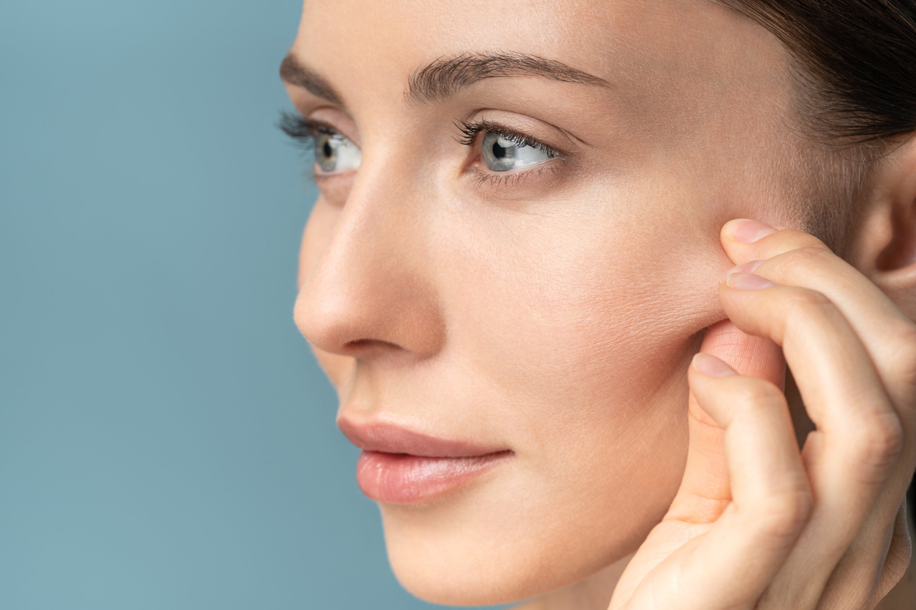 Barefaced Woman Touching Her Cheeks Up Close